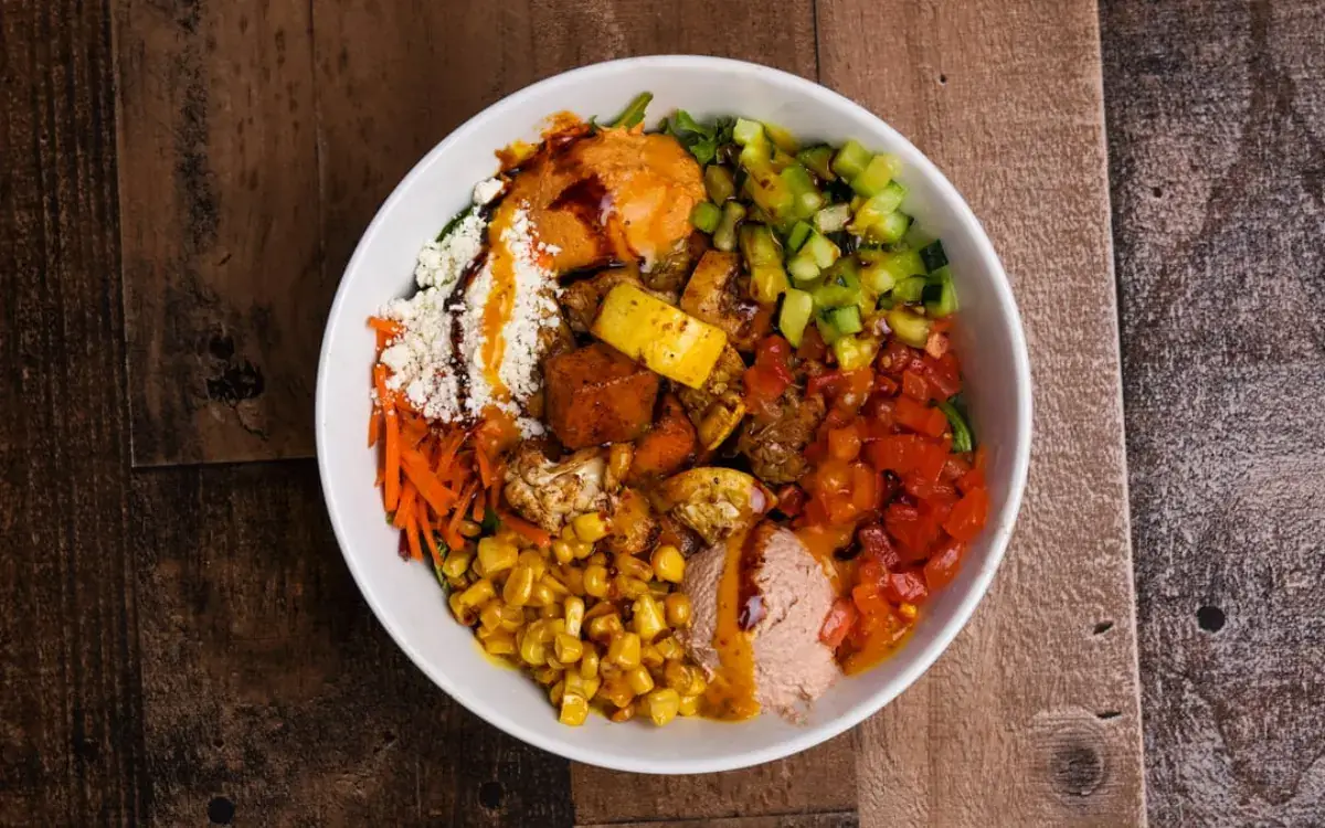 Roasted vegetable bowl with feta, corn, peppers and cucumber