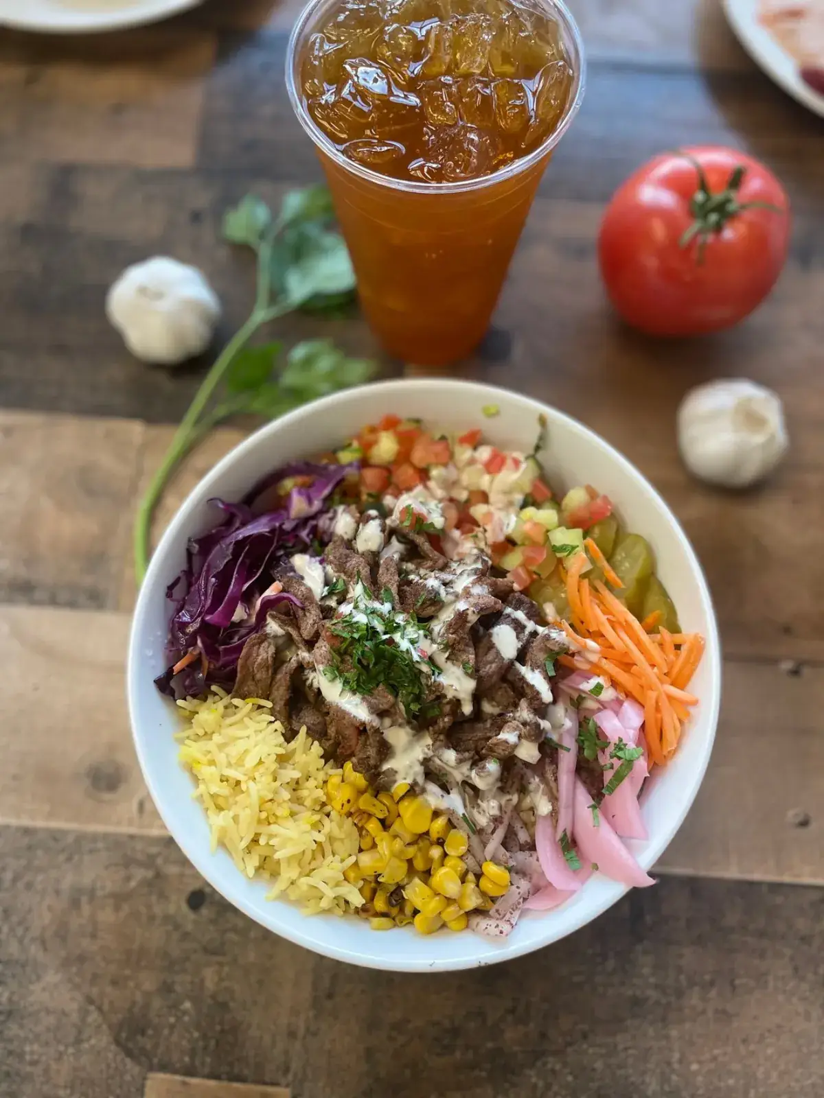 Steak bowl with saffron rice, corn, carrots, cabbage and tahini